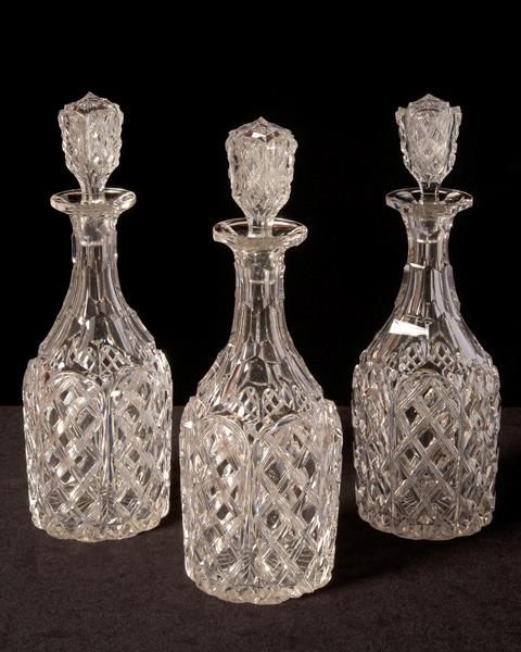 Set of three cut crystal decanters with stoppers, England, circa